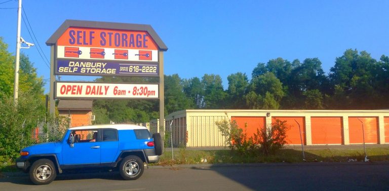Blue car in front of self storage units